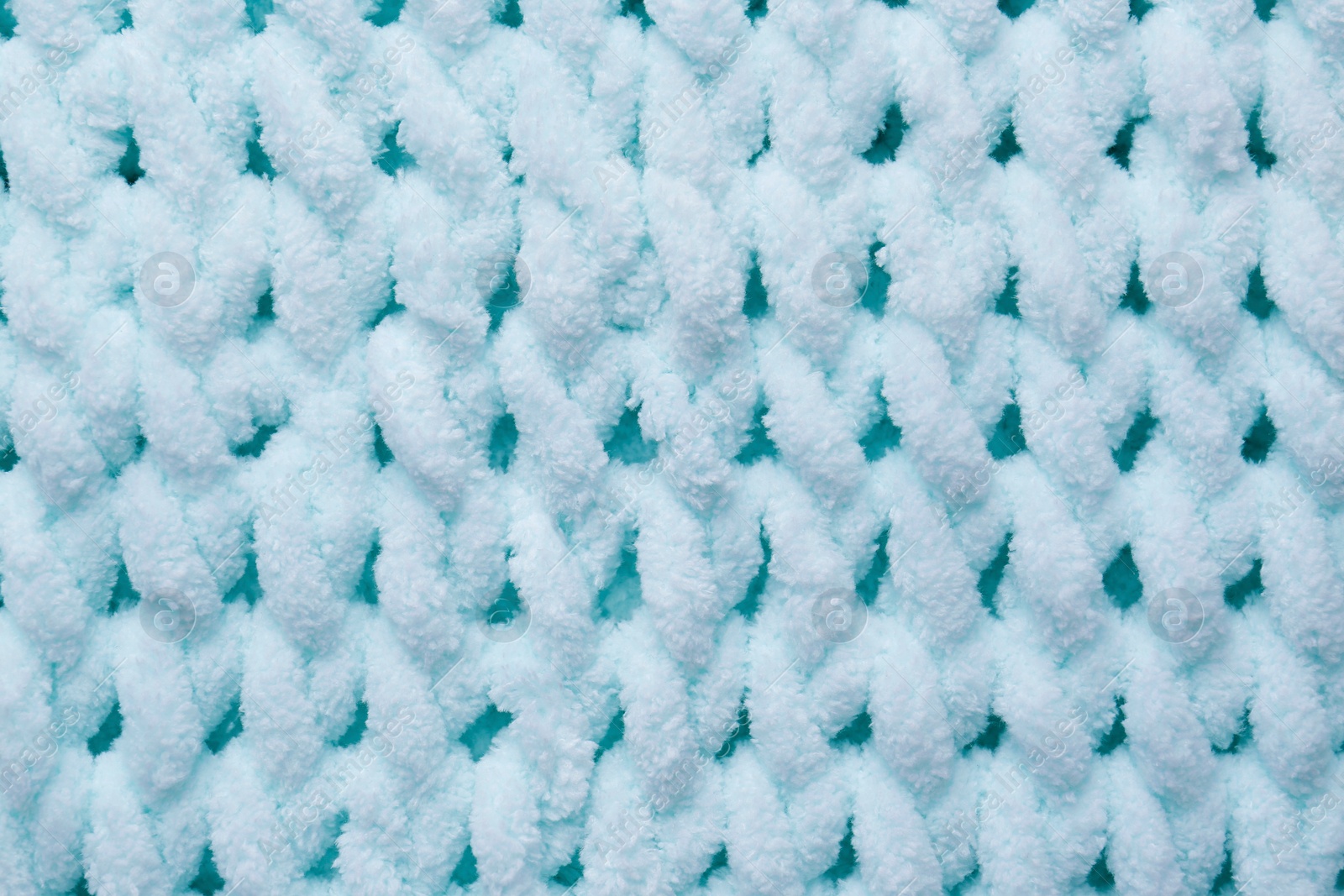 Photo of Soft light blue knitted fabric as background, top view
