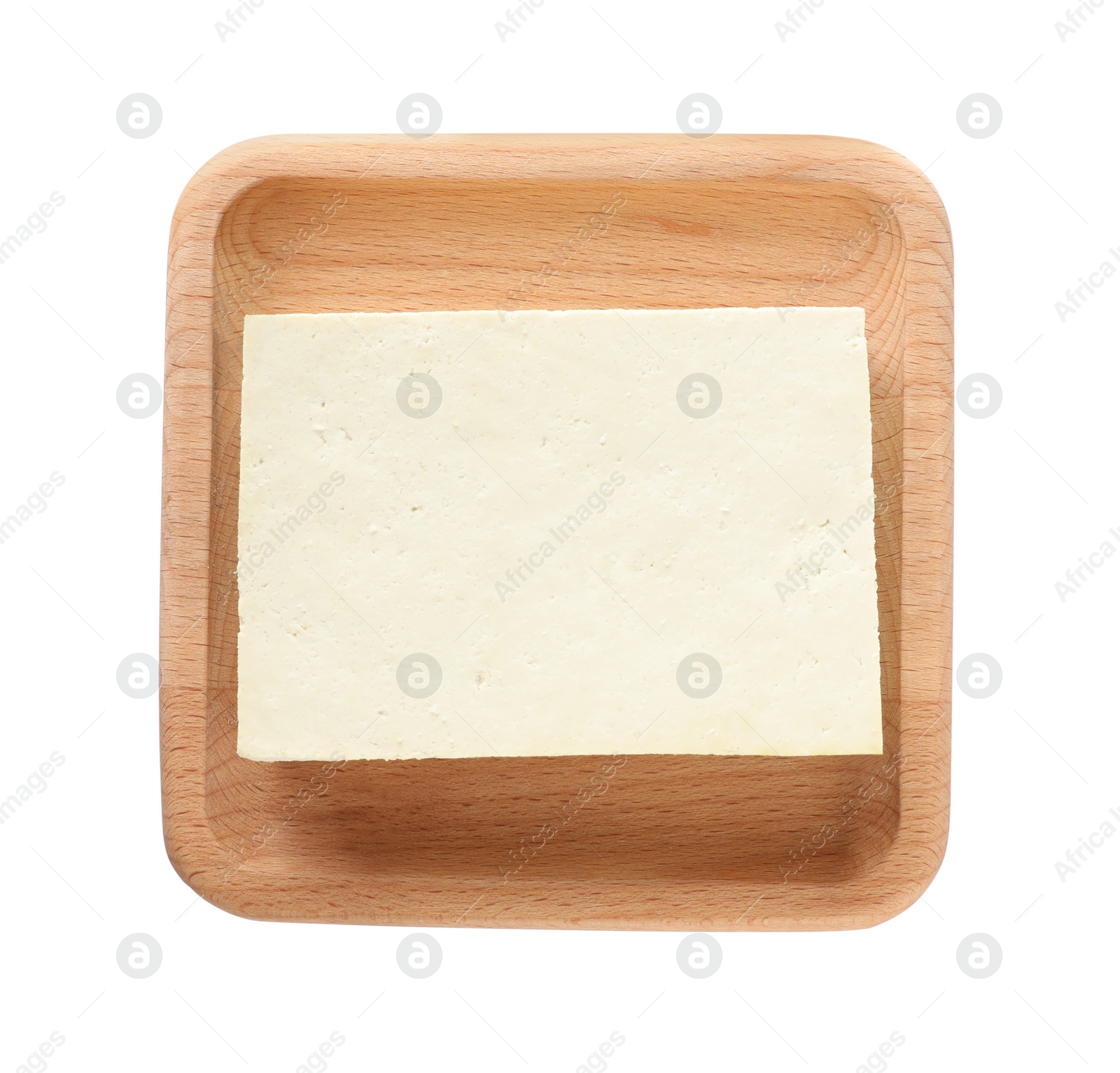 Photo of Wooden plate with delicious raw tofu isolated on white, top view