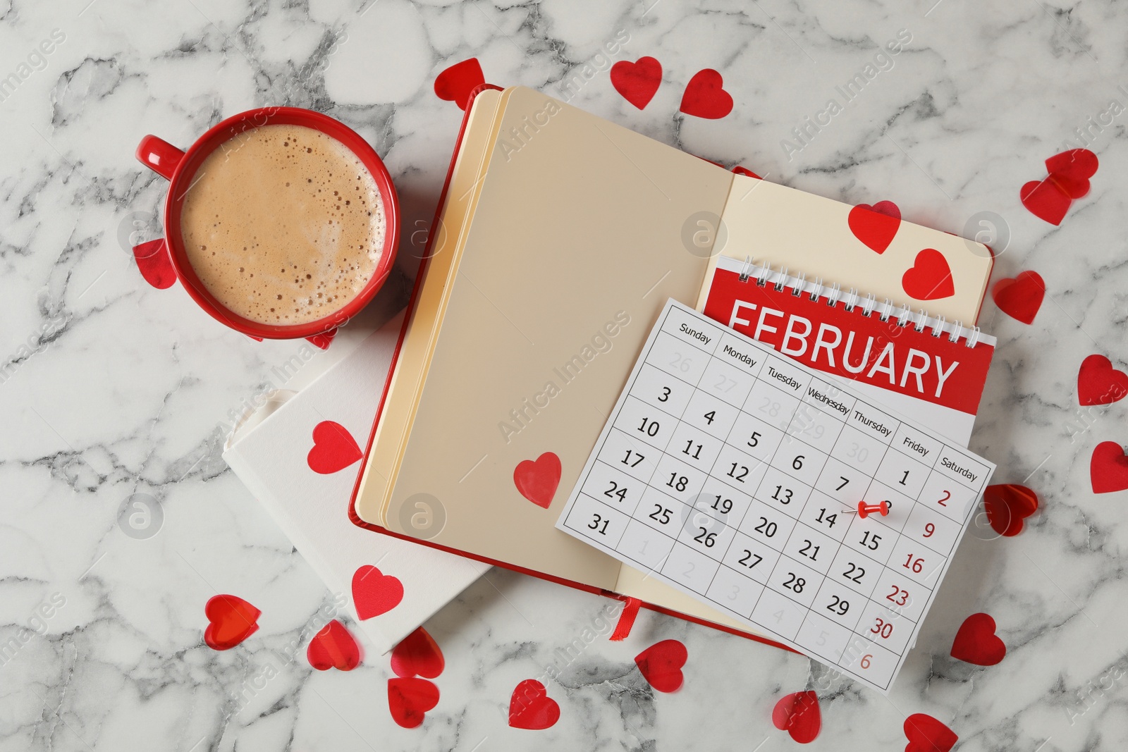 Photo of Calendar with marked Valentine's Day, notebooks and cup of coffee on white marble table, flat lay