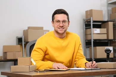 Seller with parcels working in office. Online store