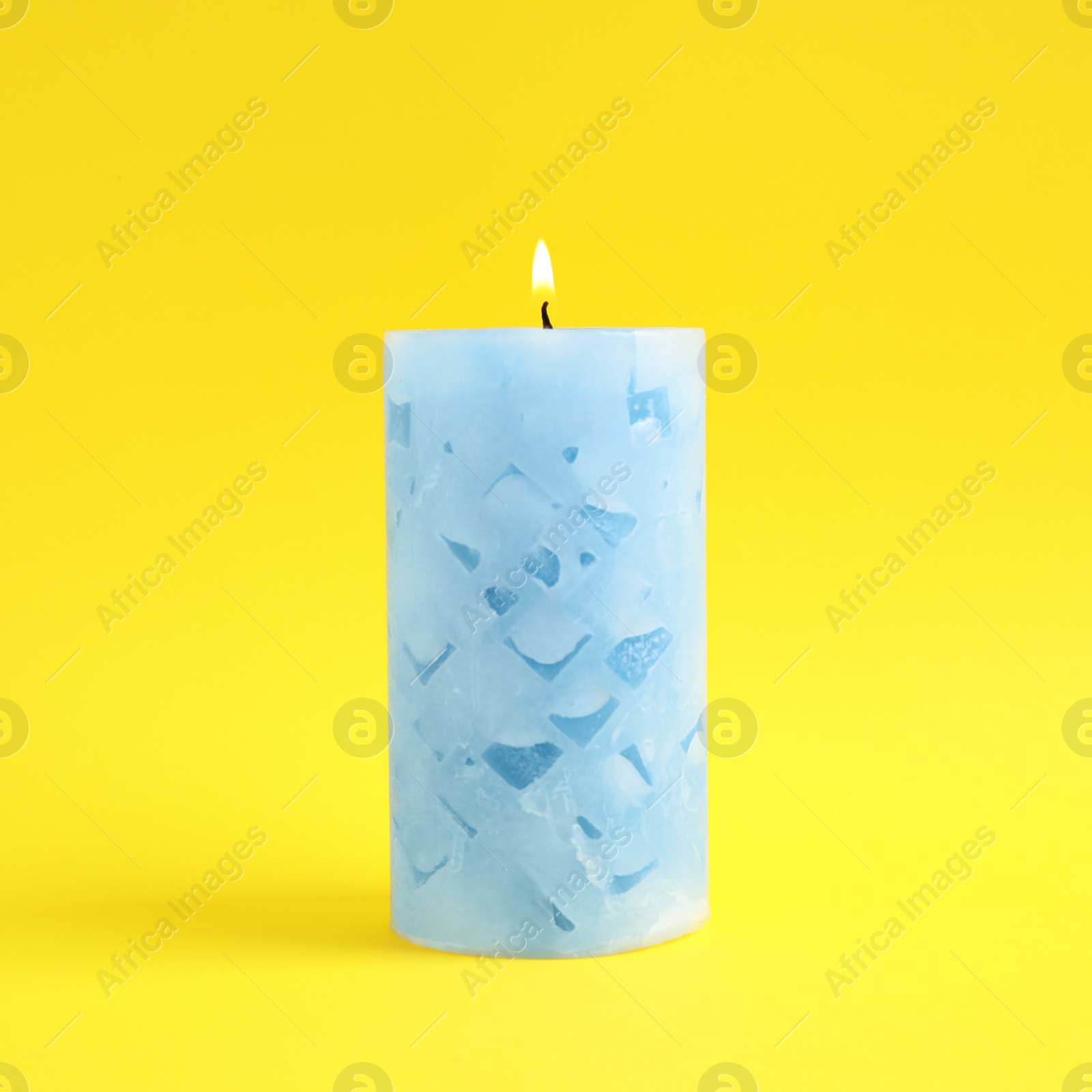 Photo of Alight scented wax candle on color background