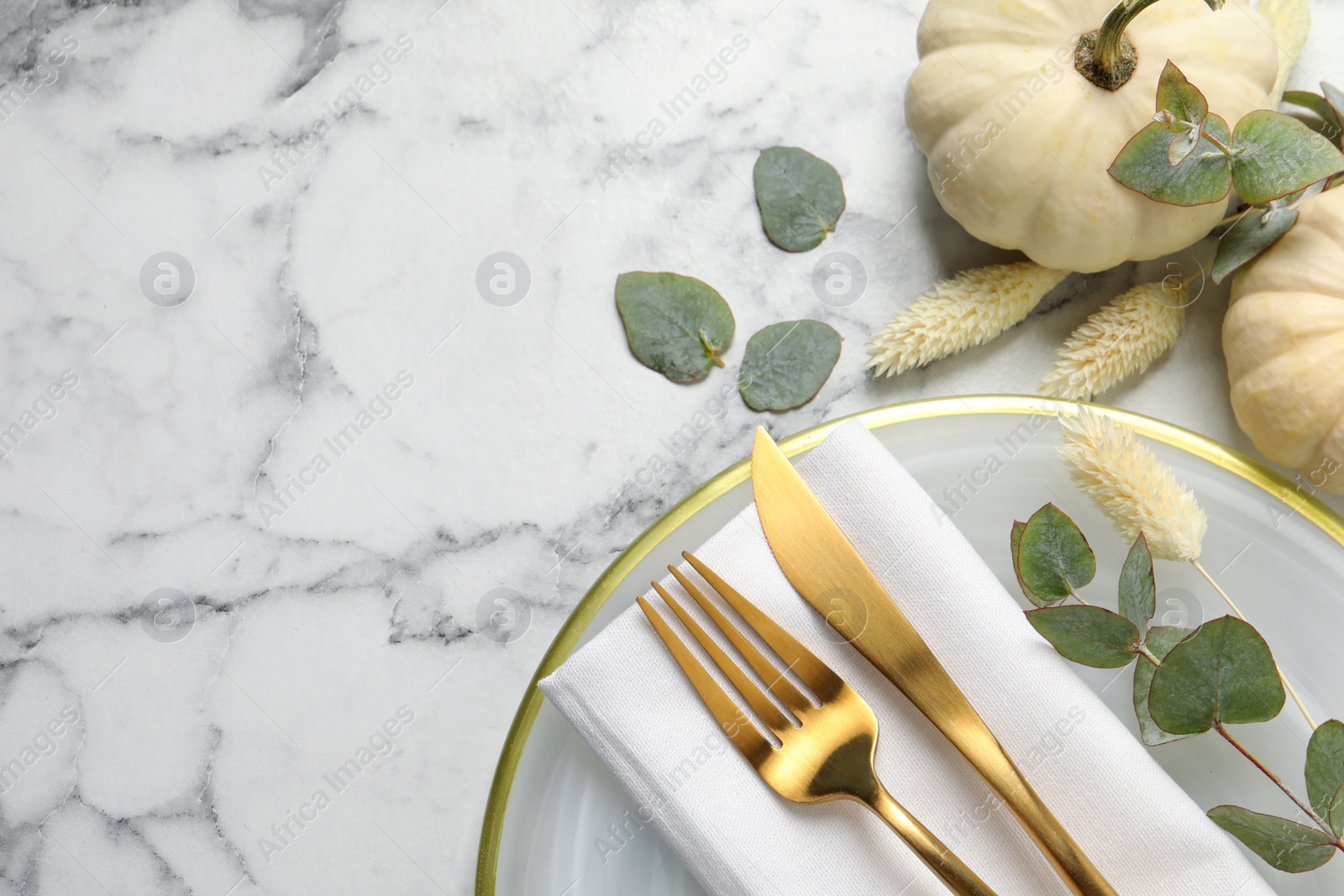 Photo of Festive table setting with autumn decor on white marble background, flat lay. Space for text