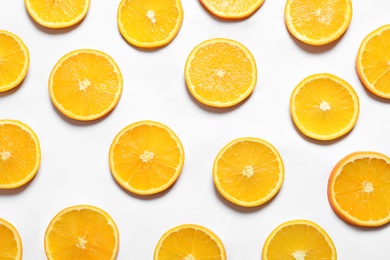 Composition with orange slices on white background, top view