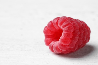 Photo of Delicious fresh ripe raspberry on white wooden table, closeup view. Space for text