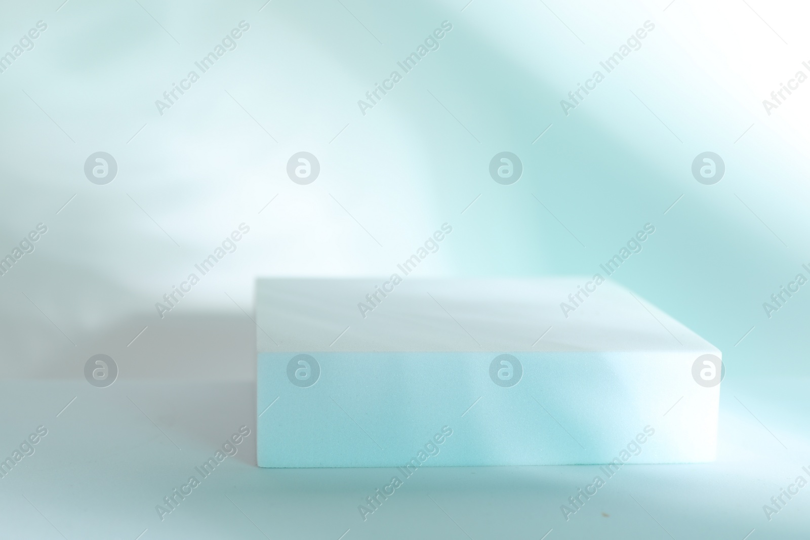 Photo of Presentation of product. Podium on light blue background, space for text