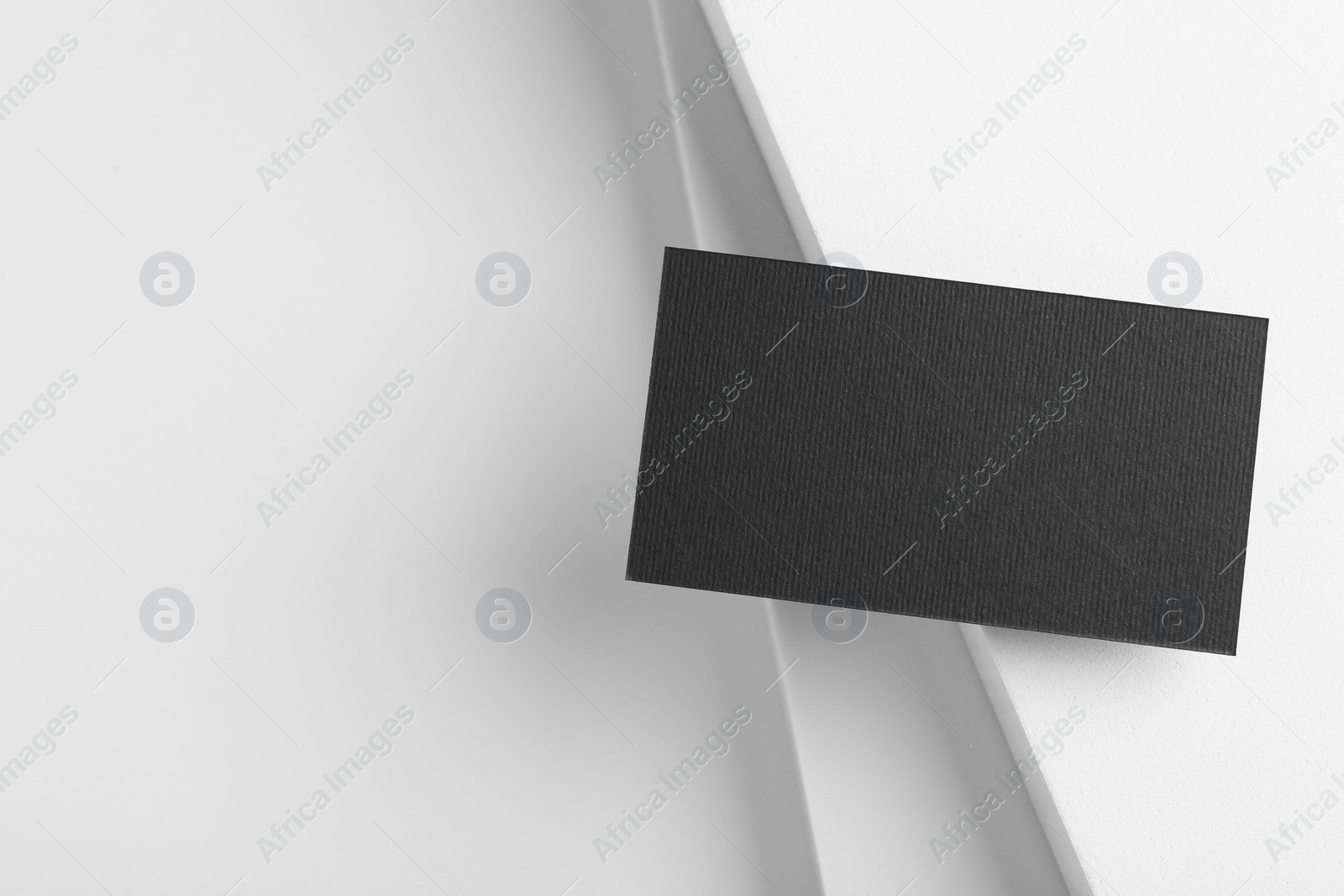 Photo of Blank black business card on light background, top view. Mockup for design