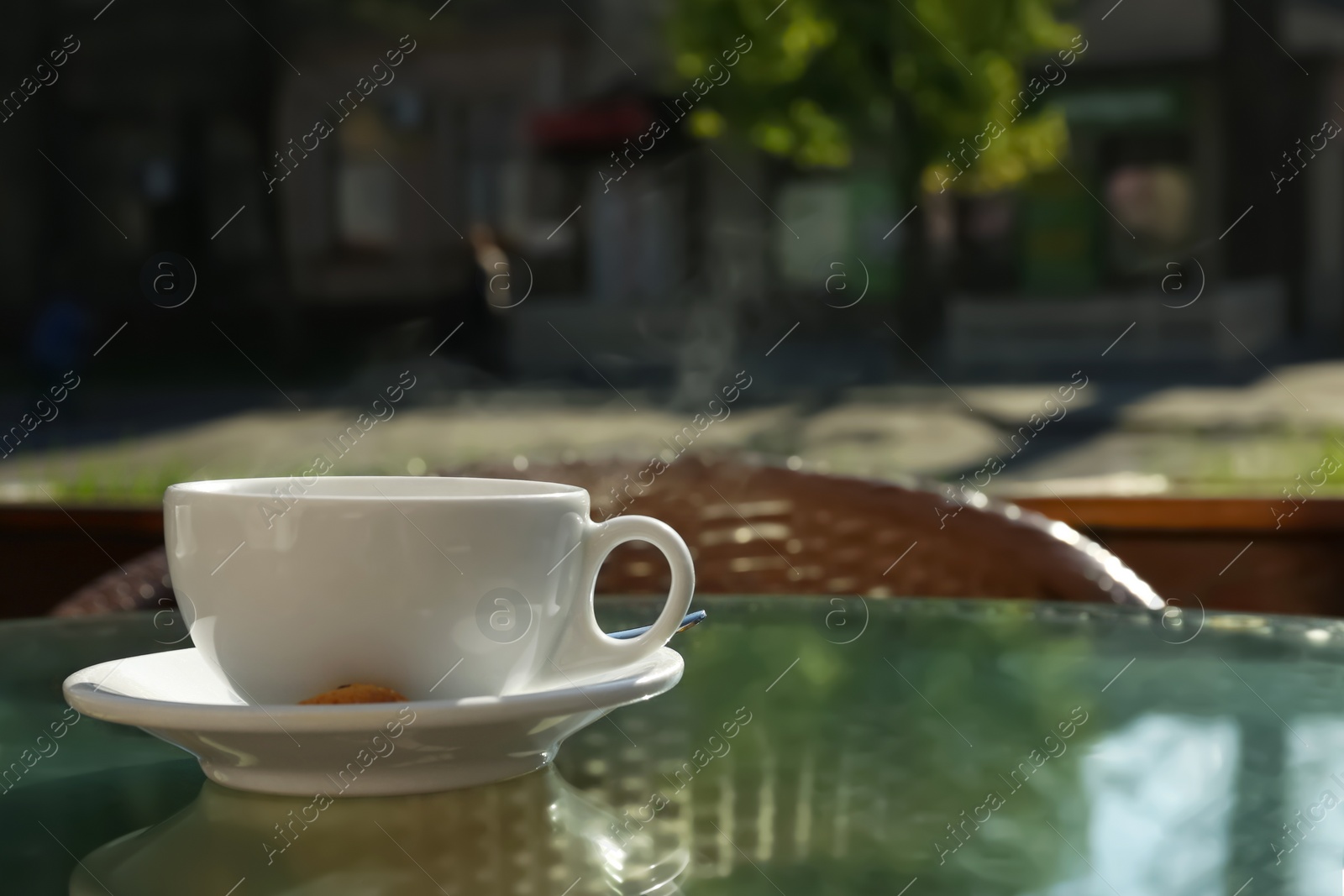 Photo of Cup of fresh aromatic coffee at table in cafe
