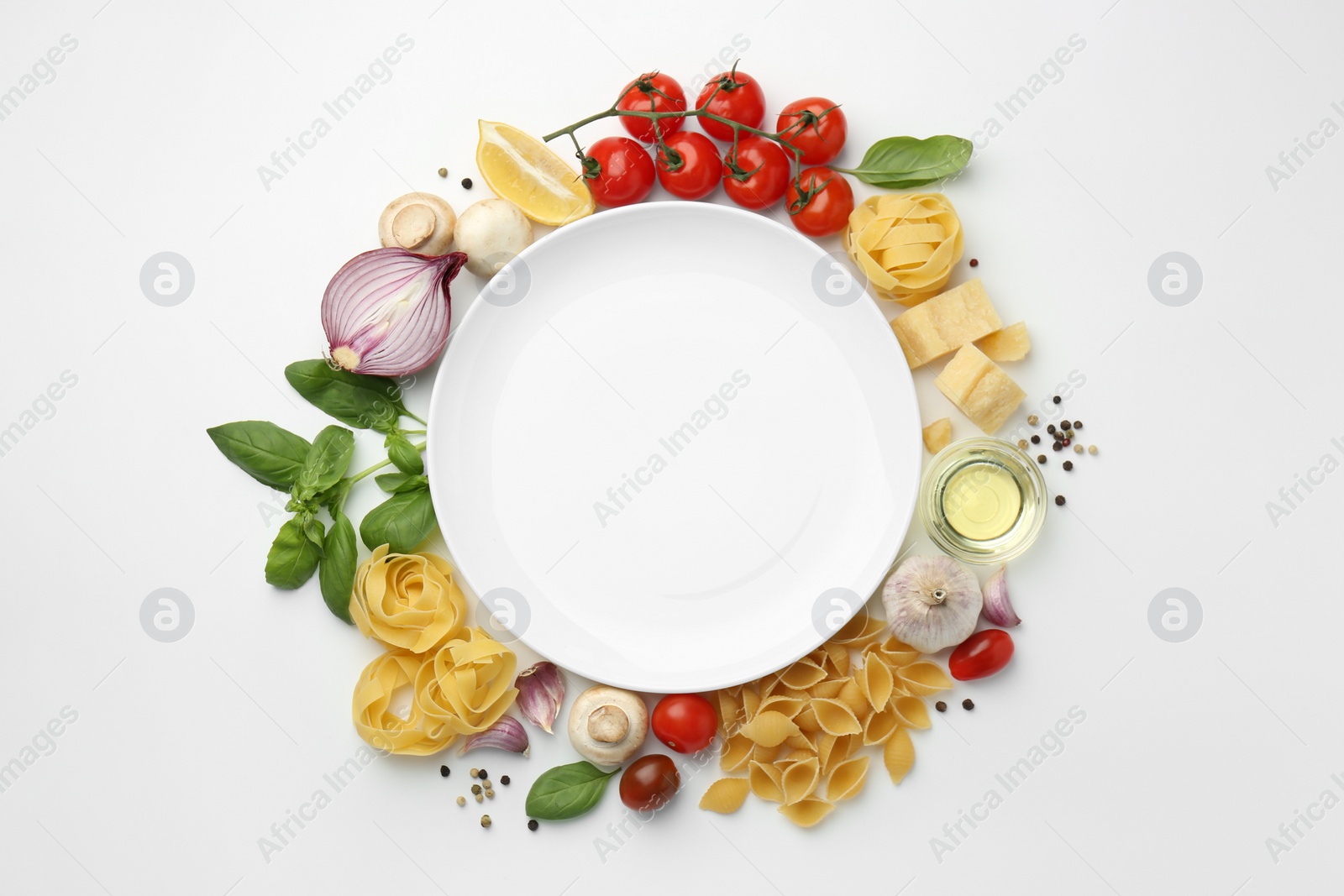 Photo of Plate surrounded by different types of pasta, products and peppercorns on white background, flat lay. Space for text