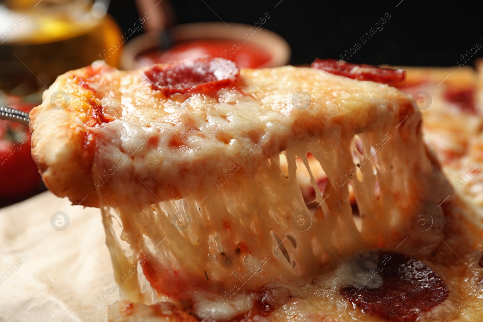 Photo of Taking slice of tasty pepperoni pizza on table, closeup