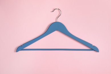 Photo of Empty clothes hanger on color background. Wardrobe accessory