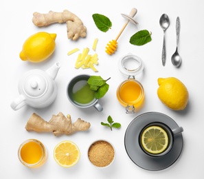 Composition with lemon tea, honey and ginger on white background, top view