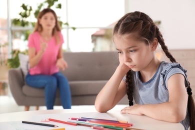 Photo of Mother scolding child at home. Family relationships