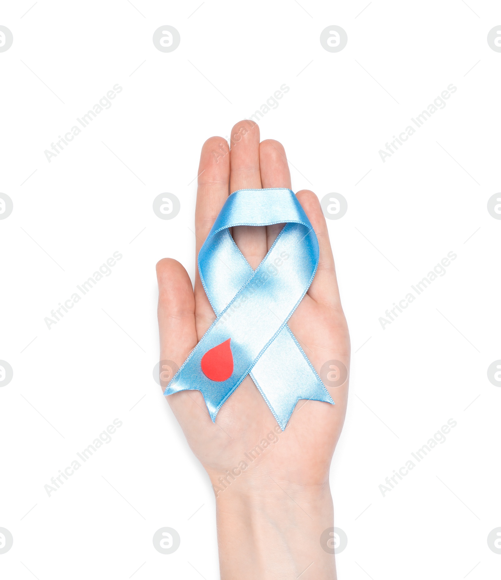 Photo of Woman holding light blue ribbon with paper blood drop on white background, top view. World Diabetes Day