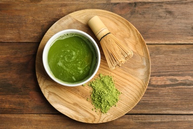 Photo of Flat lay composition with matcha tea on wooden background