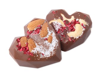 Tasty chocolate heart shaped candies with nuts on white background