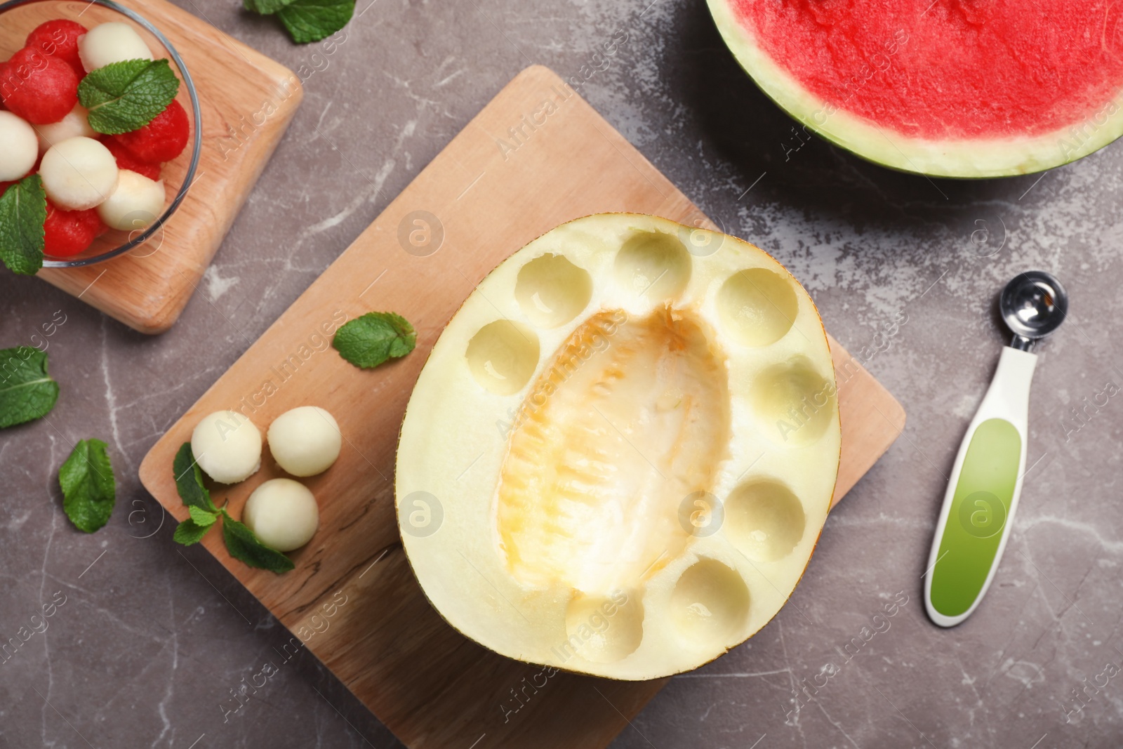 Photo of Flat lay composition with mint, melon and watermelon balls on grey background