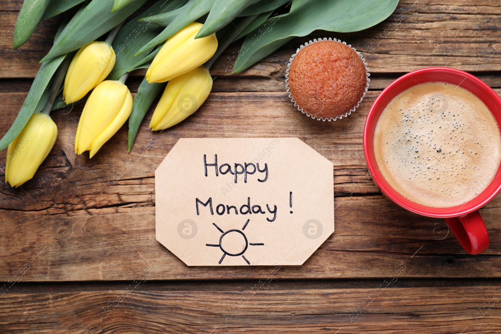 Photo of Happy Monday message, aromatic coffee, cupcake and tulips on wooden table, flat lay