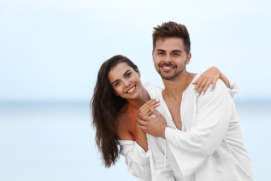 Happy young couple spending time together on beach