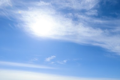 Photo of Bright sun and fluffy white clouds in blue sky