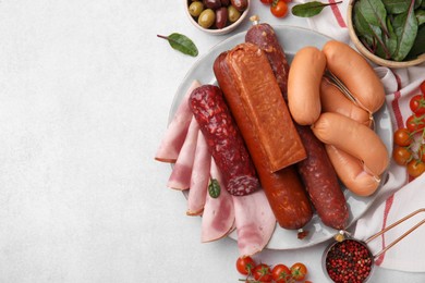 Photo of Different types of tasty sausages and ingredients on white table, flat lay. Space for text