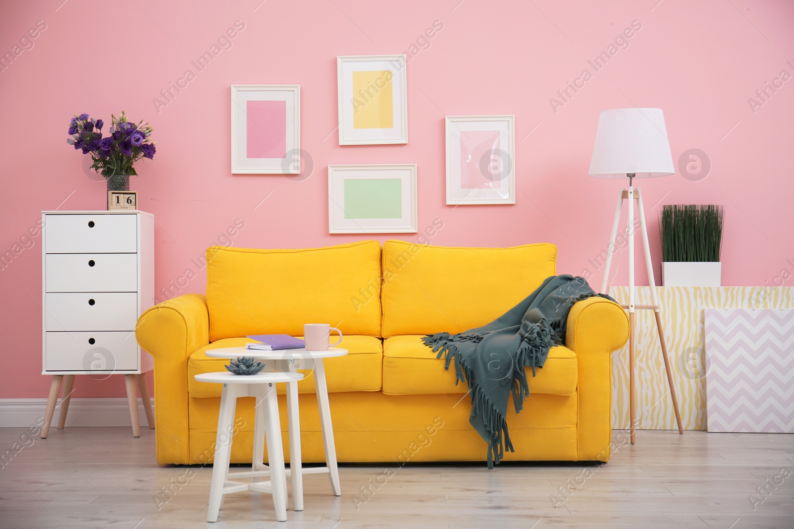 Photo of Modern living room interior with comfortable yellow sofa near color wall