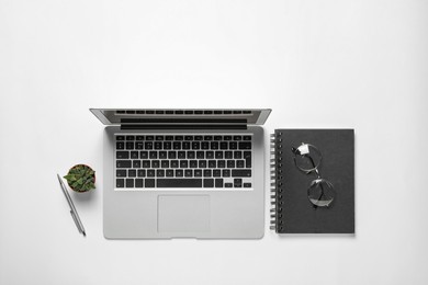 Photo of Flat lay composition with laptop on white background