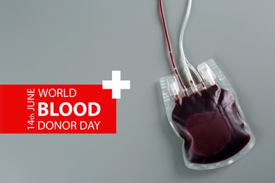 Image of World Donor Day. Blood pack on grey background, top view 