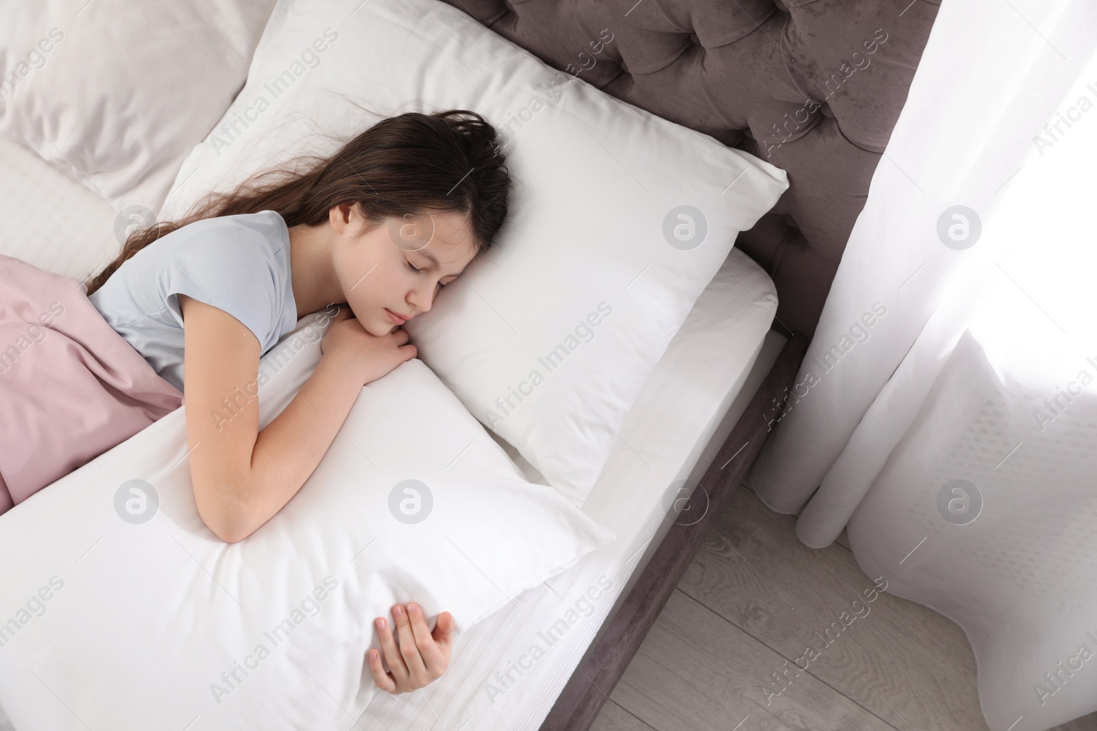 Photo of Portrait of beautiful little girl sleeping in bed, top view