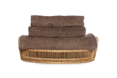 Photo of Soft towels in wicker basket on white background