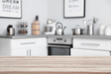 Photo of Empty table and blurred view of kitchen interior