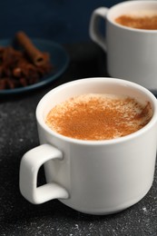 Photo of Delicious eggnog with anise and cinnamon on grey table