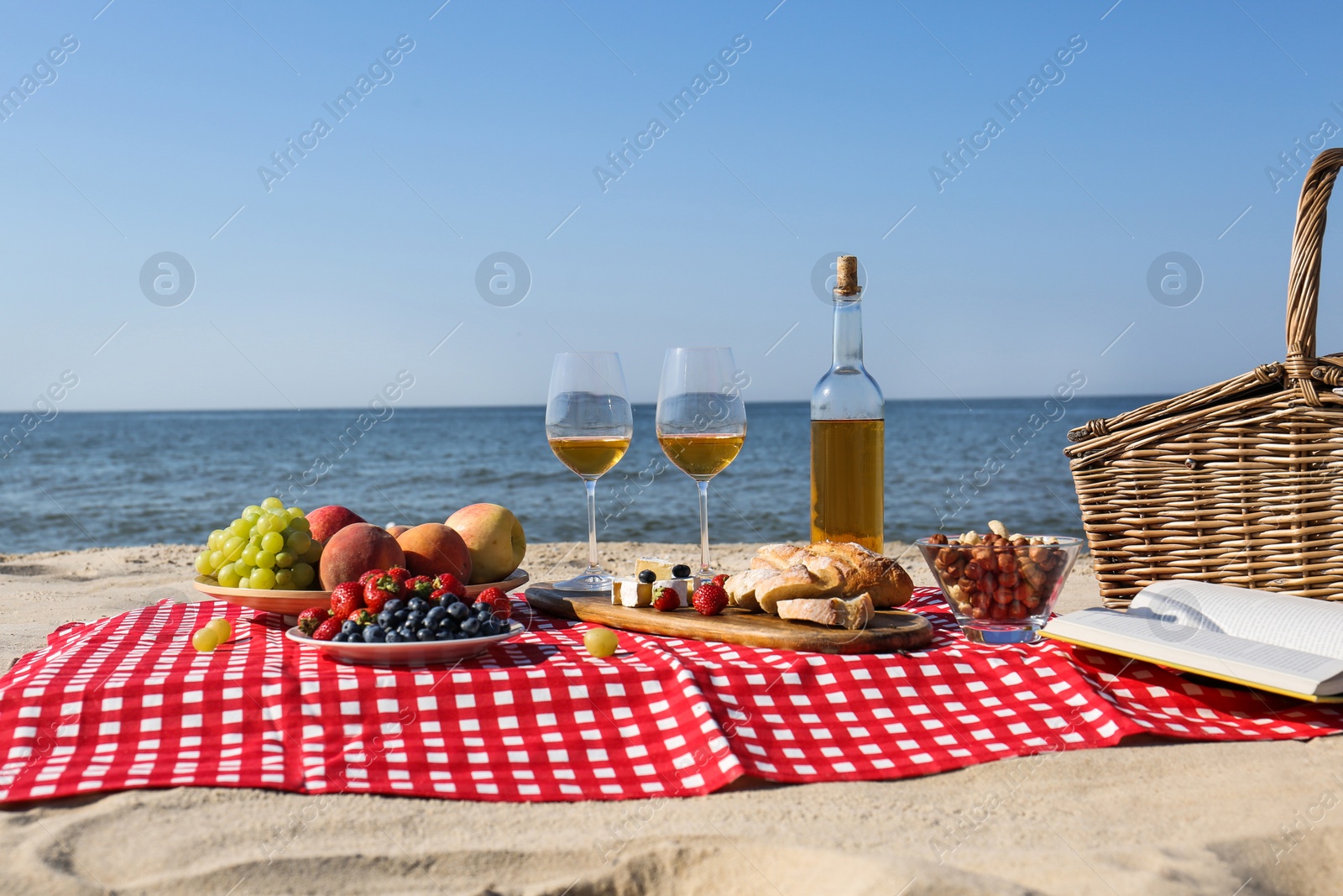 Photo of Food and wine on beach. Summer picnic