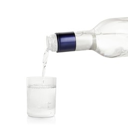 Photo of Pouring vodka from bottle in glass on white background