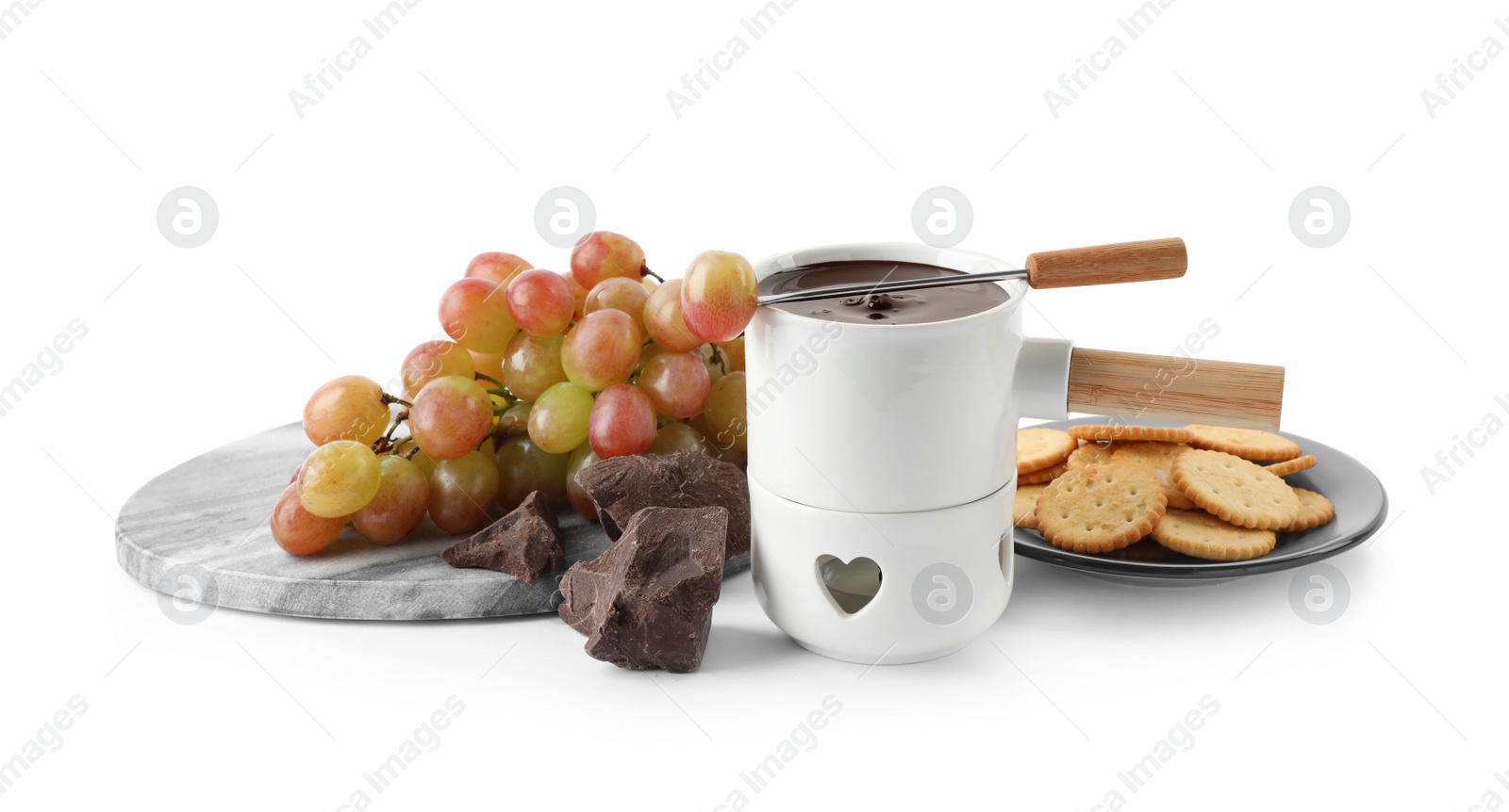 Photo of Fondue pot with chocolate and grape on white background