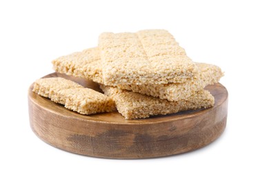 Wooden board with tasty sesame kozinaki bars on white background