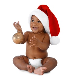 Cute African-American baby wearing Santa hat with Christmas decoration on white background