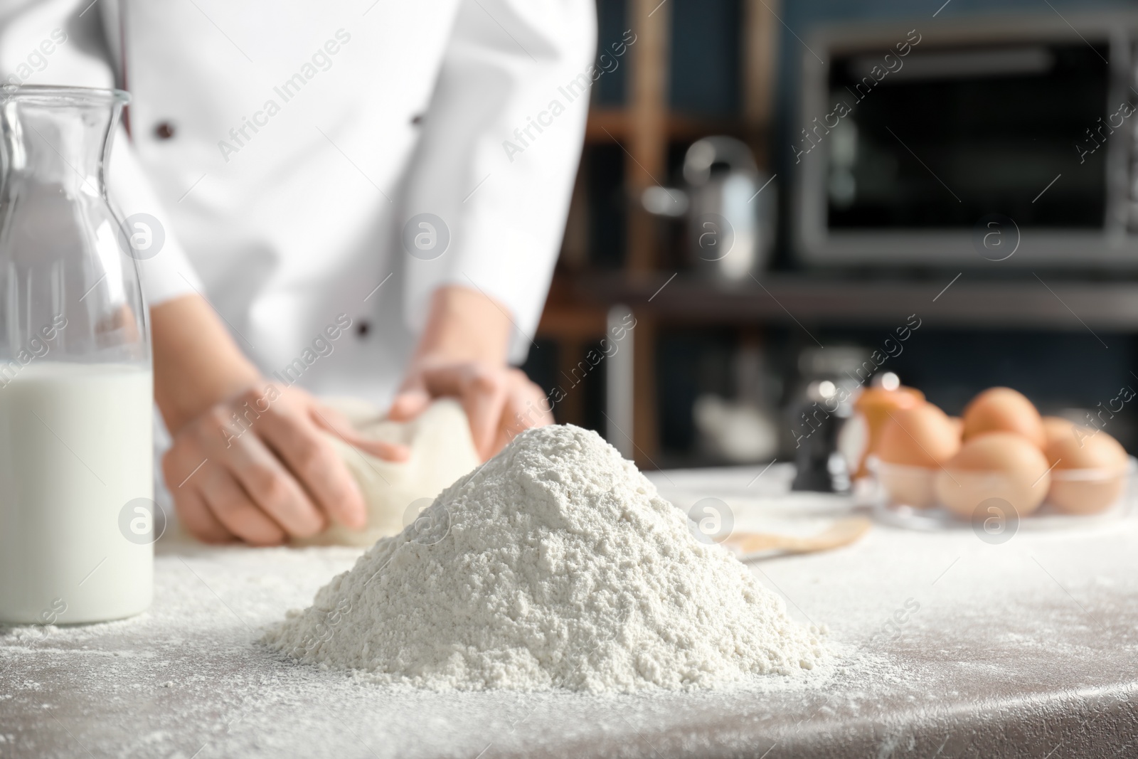 Photo of Pile of flour and chef on background