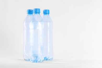 Plastic bottles with pure water on white background