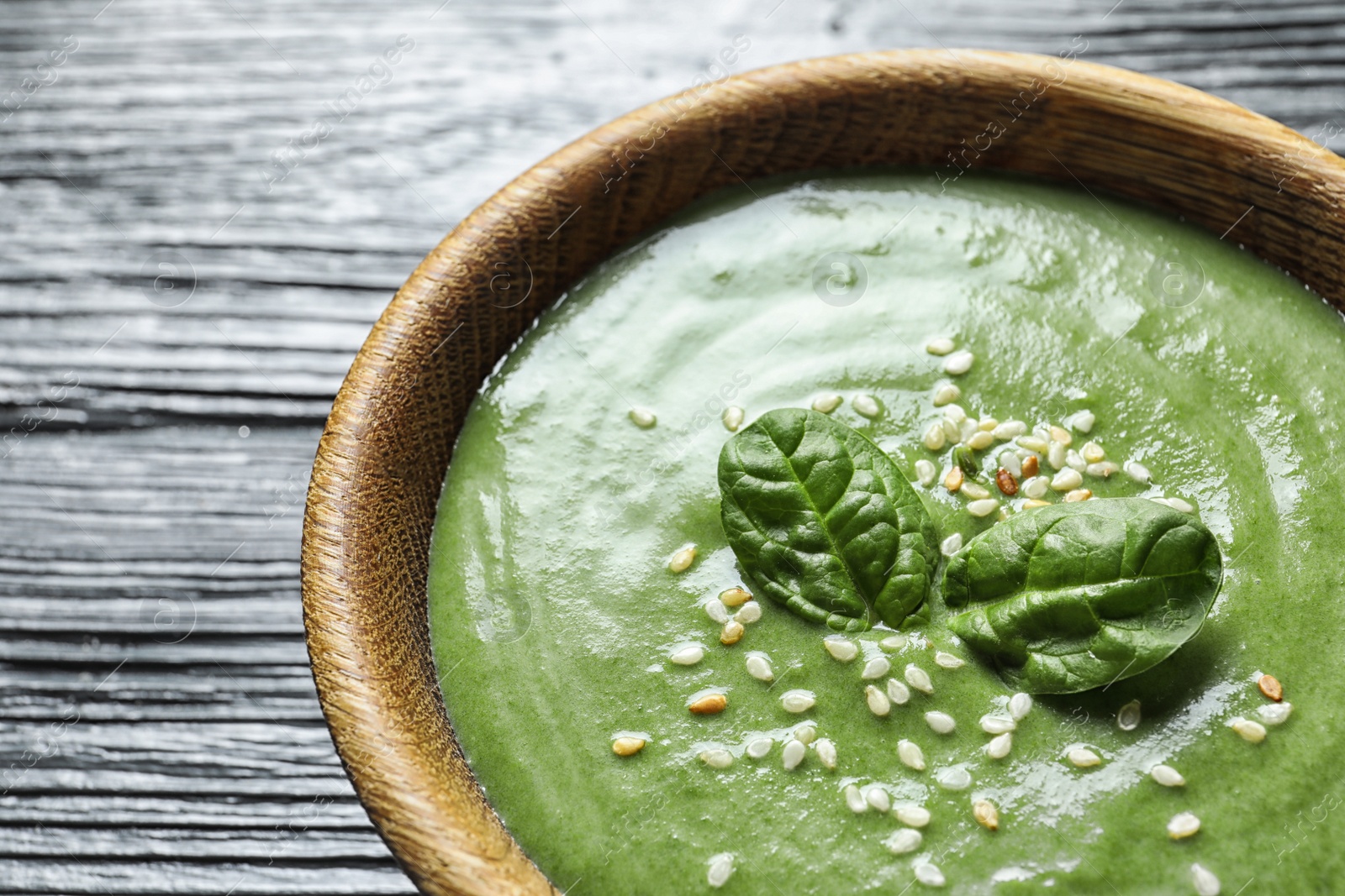 Photo of Fresh vegetable detox soup made of spinach in dish on table, closeup