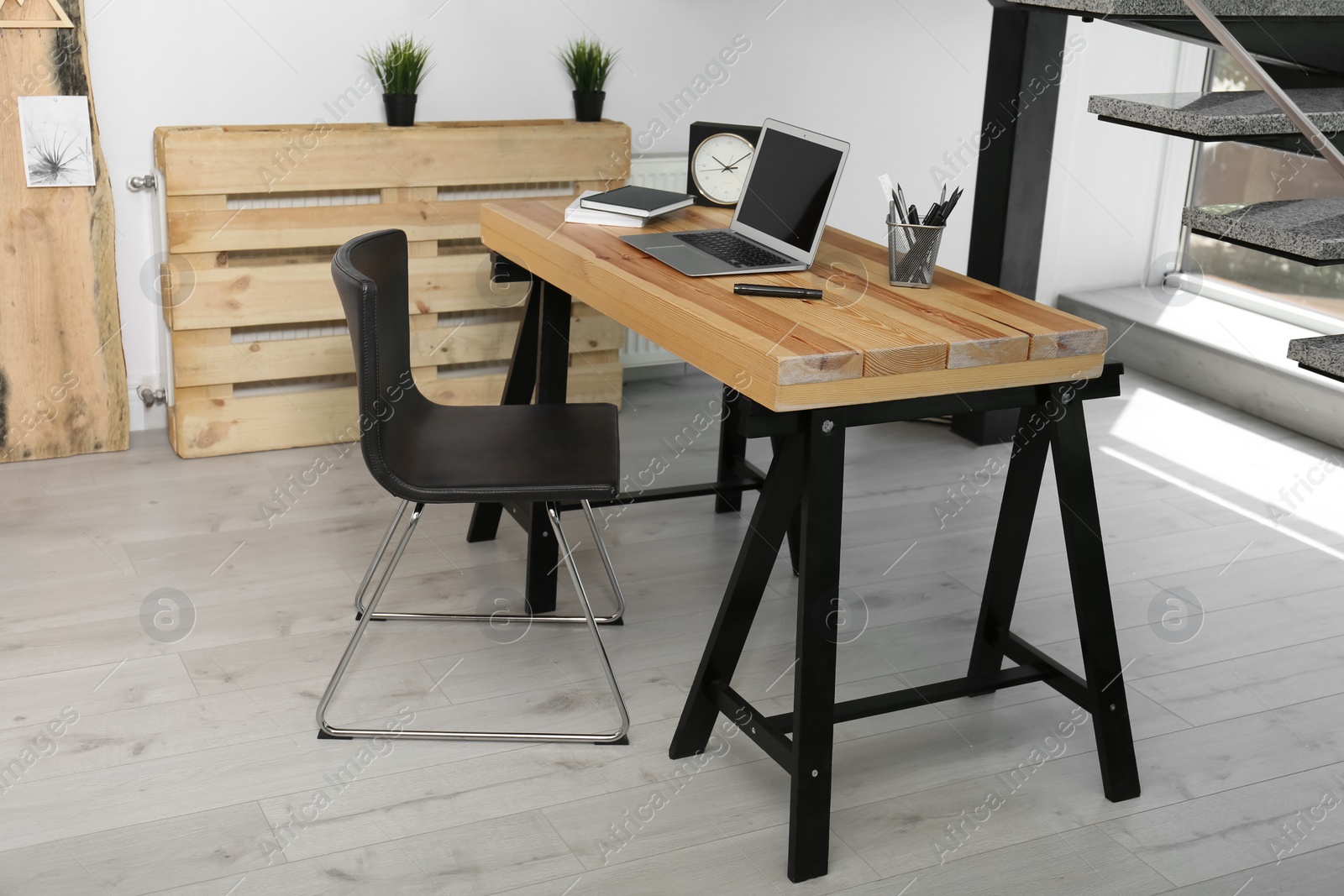 Photo of Comfortable workplace with office chair and wooden table