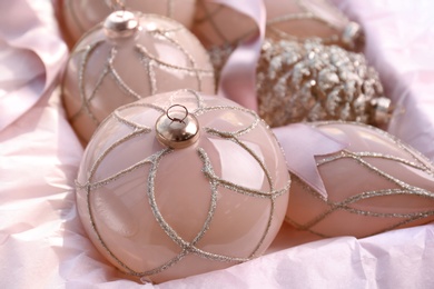 Photo of Set of beautiful Christmas baubles and ribbon in box, closeup