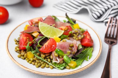 Photo of Plate of salad with mung beans on white table, closeup