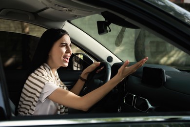 Photo of Stressed young woman driver's seat of modern car
