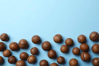 Photo of Organic Macadamia nuts and space for text on color background, top view
