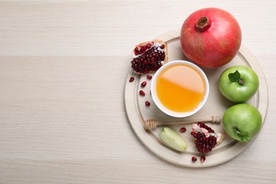 Photo of Honey, pomegranate and apples on wooden table, top view with space for text. Rosh Hashana holiday