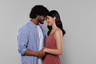 Photo of International dating. Portrait of happy couple on light grey background, space for text
