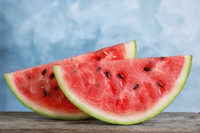 Photo of Fresh juicy watermelon slices on wooden table