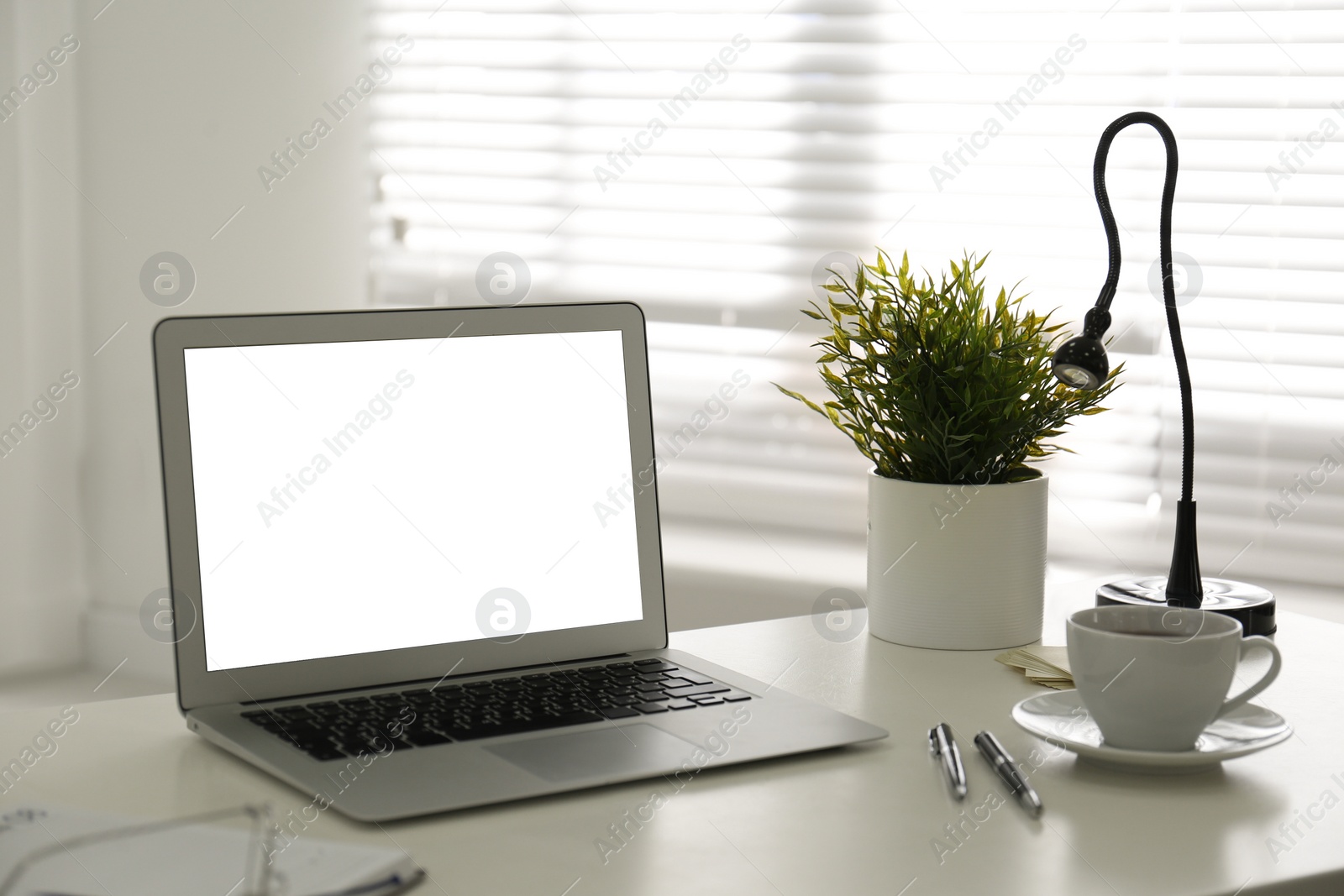 Photo of Modern laptop on office table. Stylish workplace