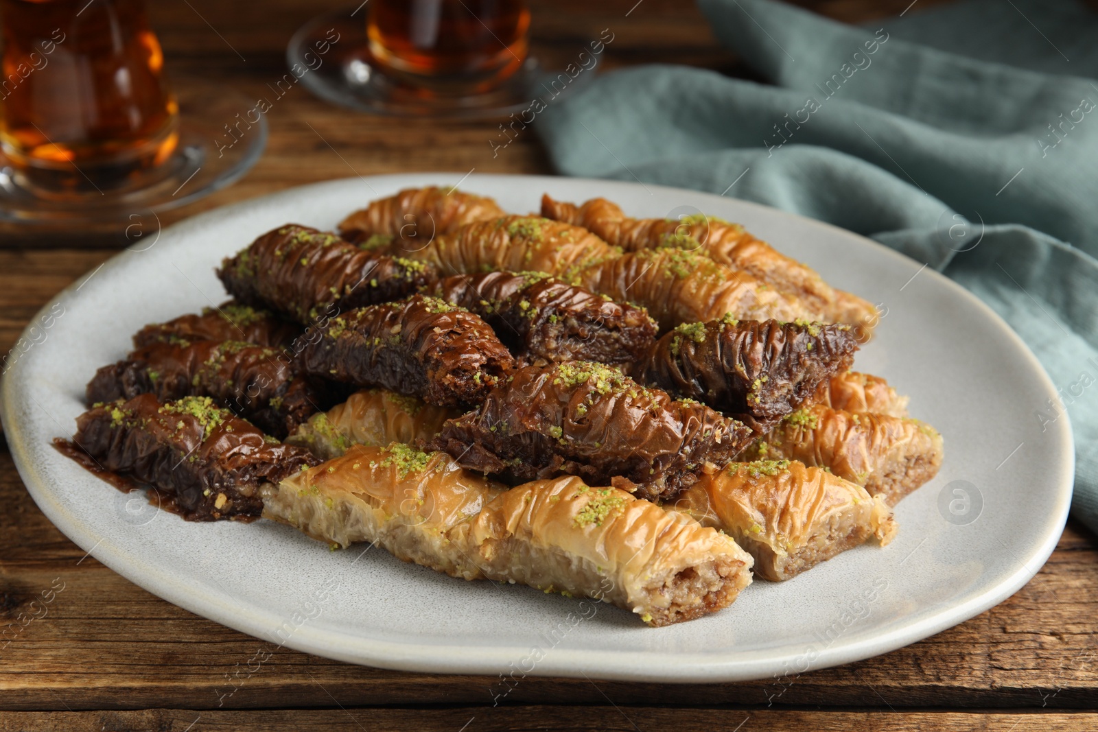 Photo of Delicious baklava with pistachios on wooden table