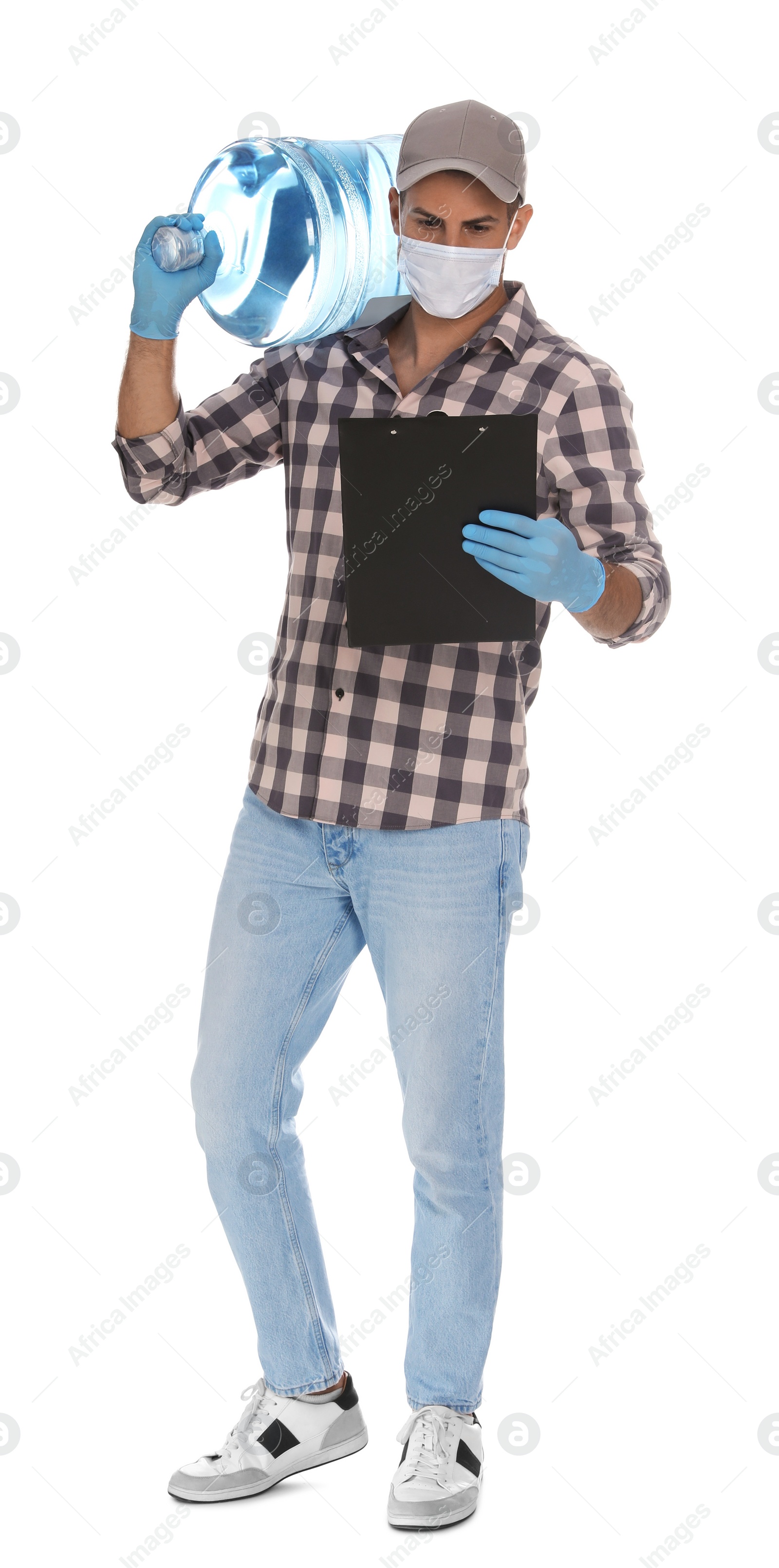 Photo of Courier in medical mask with bottle for water cooler and clipboard on white background. Delivery during coronavirus quarantine